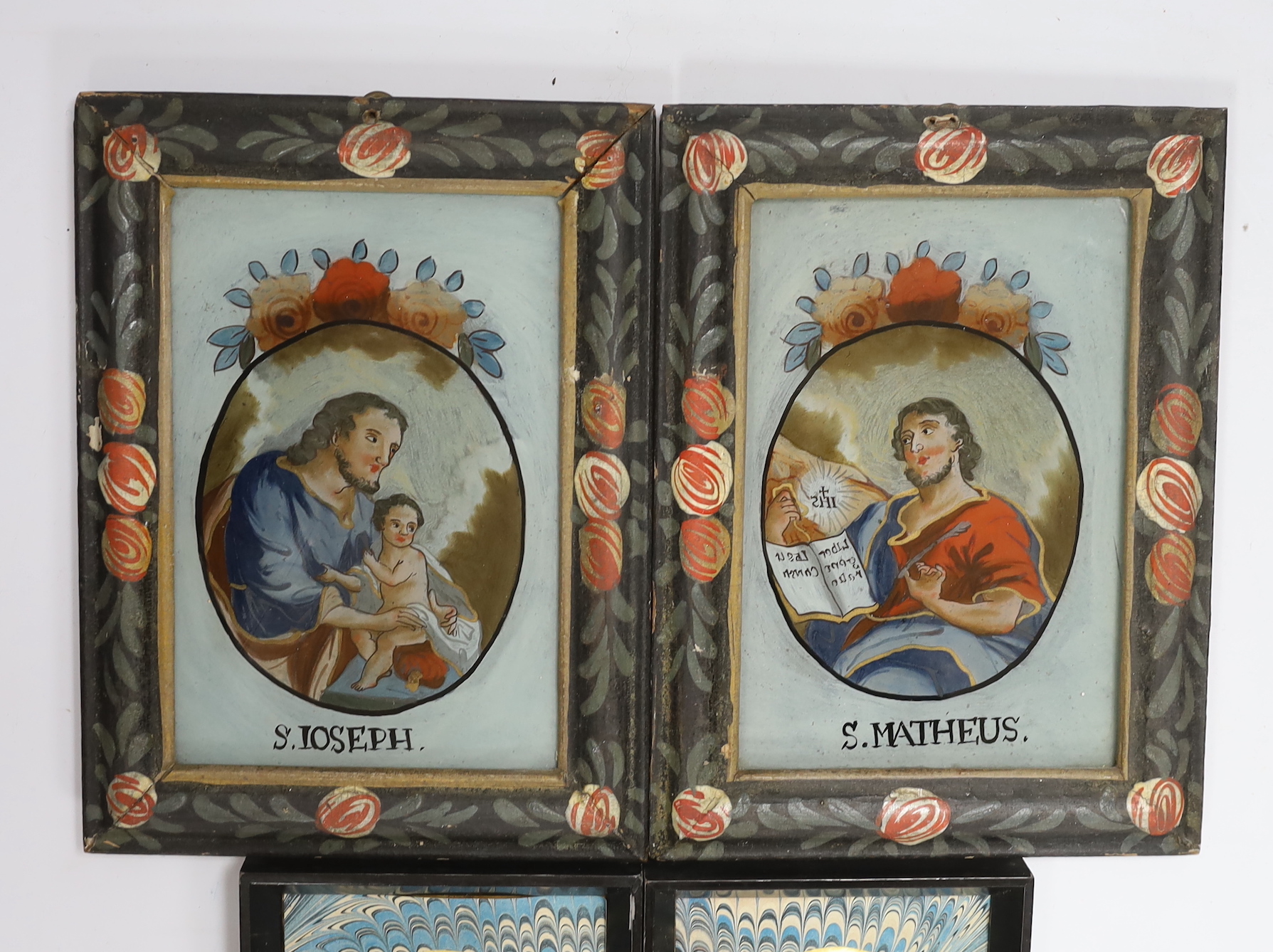 A pair of small reverse painted glass silhouettes, a pair of reverse painted glass panels of St Joseph and St Matheus and an oval plaster relief profile of a Regency gentleman, reverse paintings 14.5cm high x 9.5cm wide